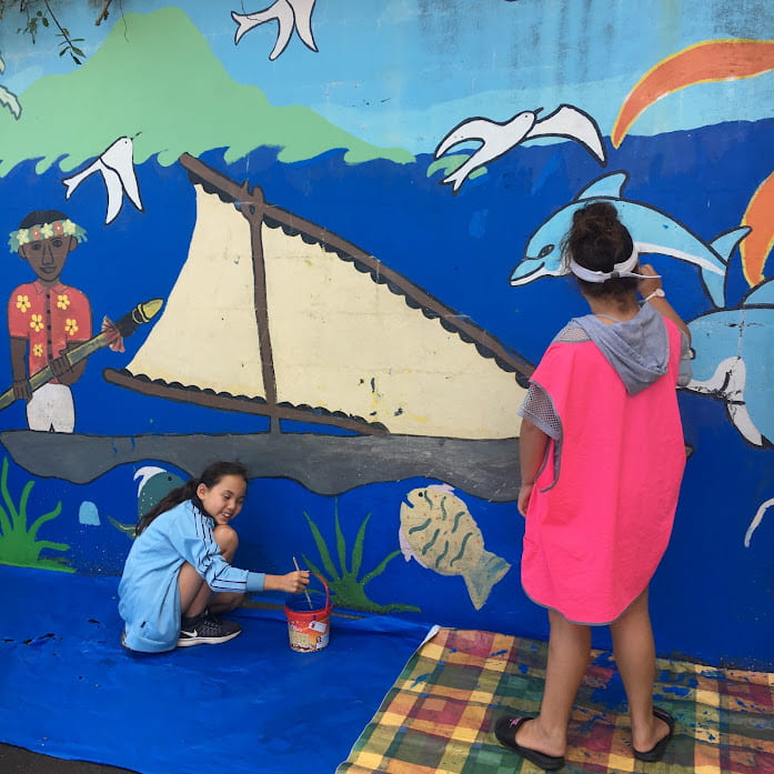 Kids painting a mural